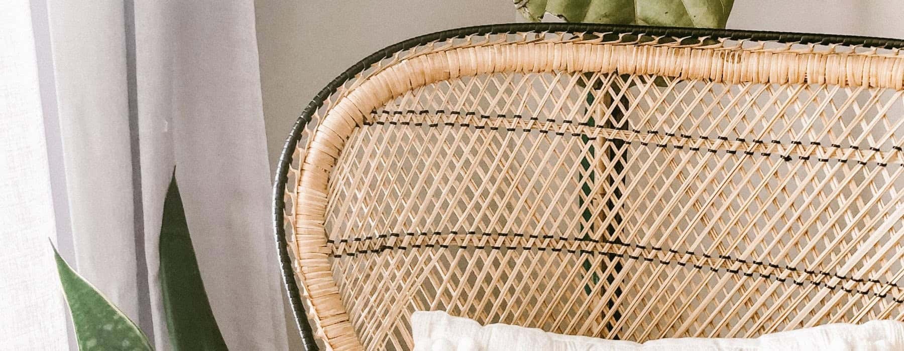 a wicker chair and a white pillow